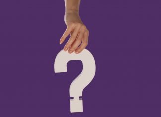 What Is Biosil? Does it Work for Hair Loss? What Is Biosil? Does it Work for Hair Loss; Female hand holding up a white question mark against a purple background conceptual of questions, query, why or what.